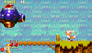 Eggman has a purple flame pod of his own, with twin mounted cannons. He bursts through the waterfall, over the wooden bridge and promptly sets fire to it, creating the threat of instant death. Take a few cheap shots, but don't go overboard.