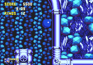 The second to last Special Stage ring appears in the room above the rotating ladder drums, which occur after the point where the two alternate routes merge. Two otherwise unnecessary blocks floating in the middle of the room suggest the ring's presence in the right hand wall.