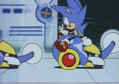 Sonic takes a ride downward on one of Wacky Workbench's circular platforms to be met by three enemies from Metallic Madness.